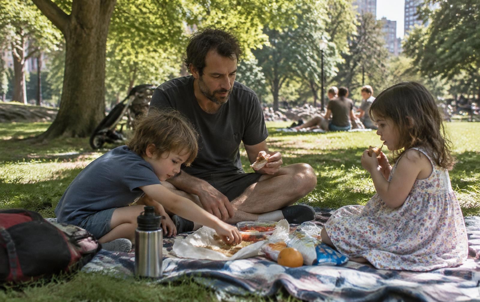 A father and two kids picnicking in a city park